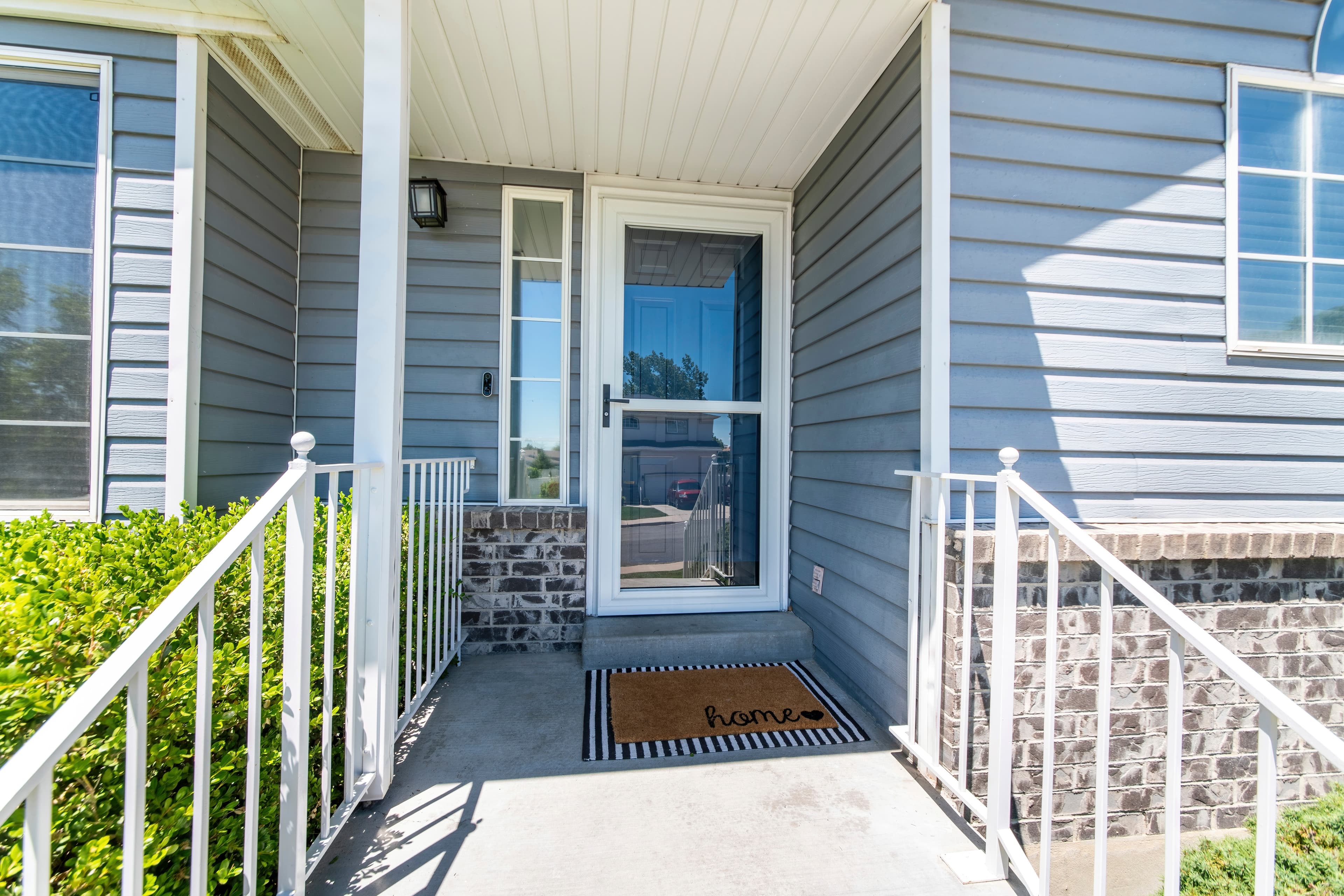 Front porch with a custom glass storm door and sidelight